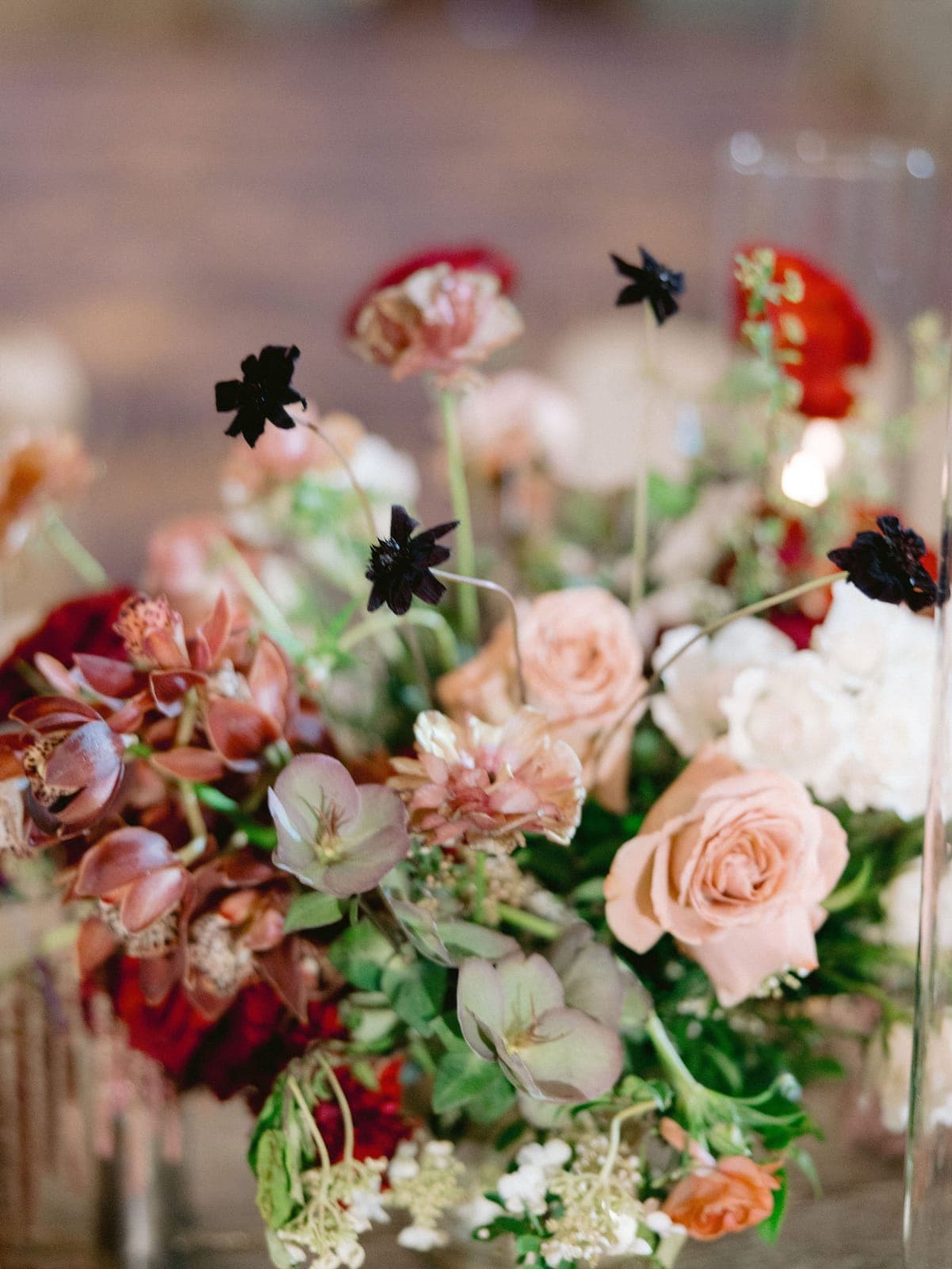Blush roses and chocolate cosmos in a Scheme reception centerpiece at Aria